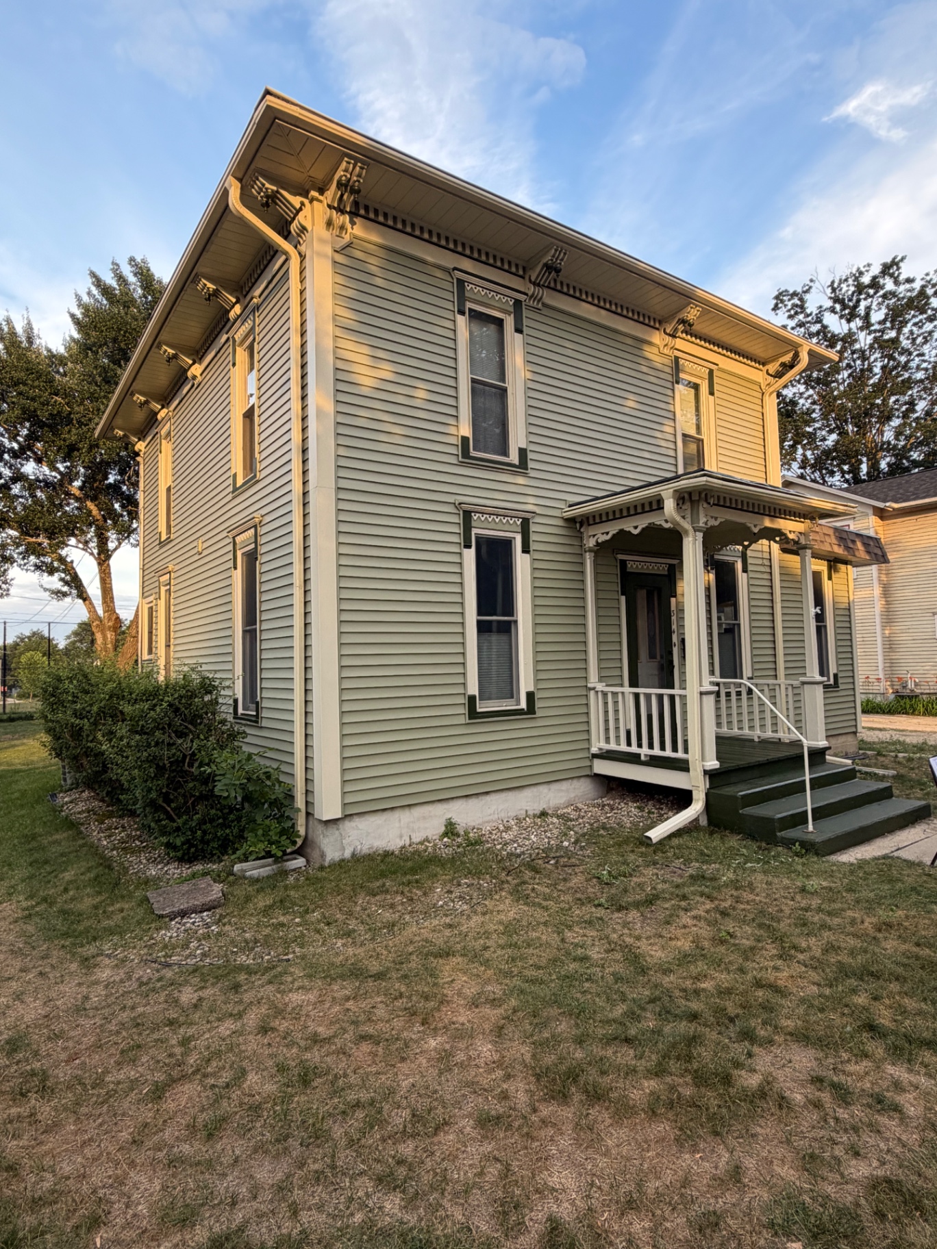 Freshly painted sage green Victorian home in Evansville, Wisconsin
