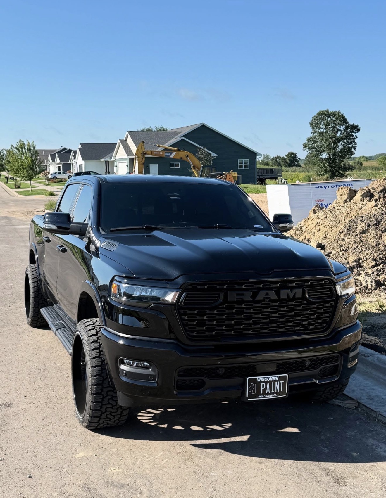 Summers Painting black Ram work truck on site