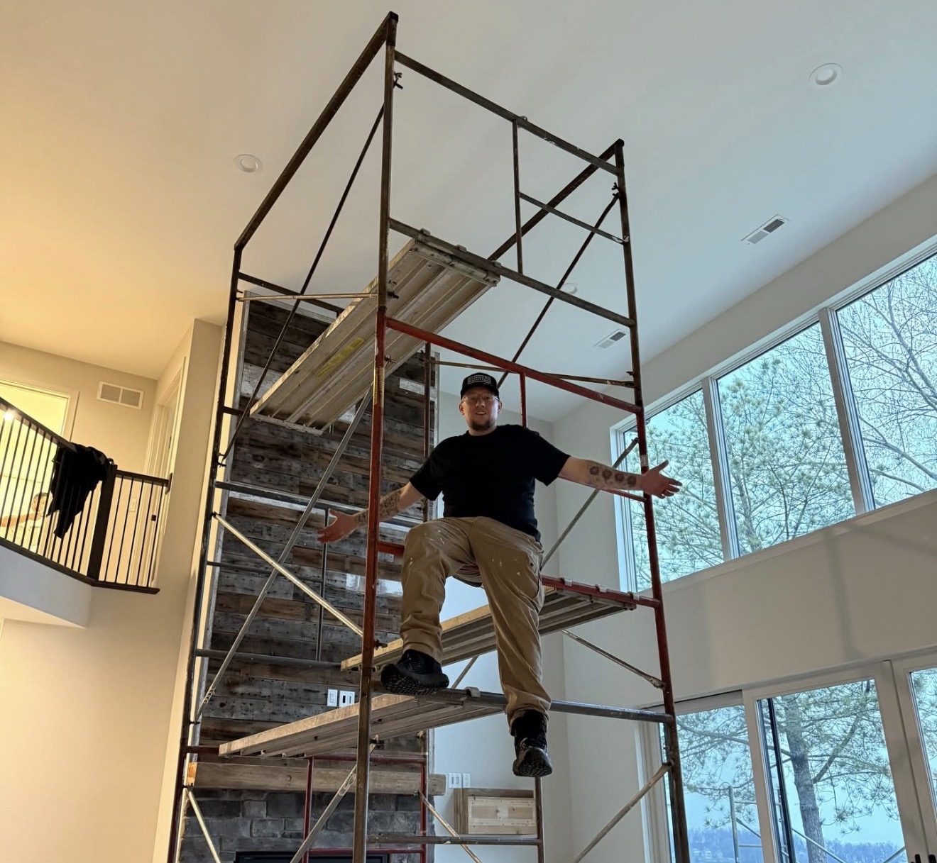 Scott Summers on scaffolding for a high ceiling interior paint job