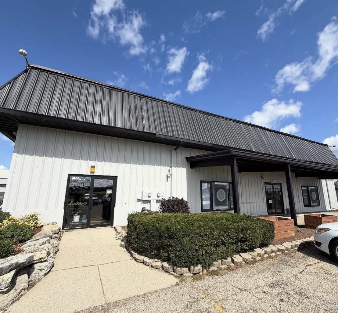 White and black commercial storefront exterior painting