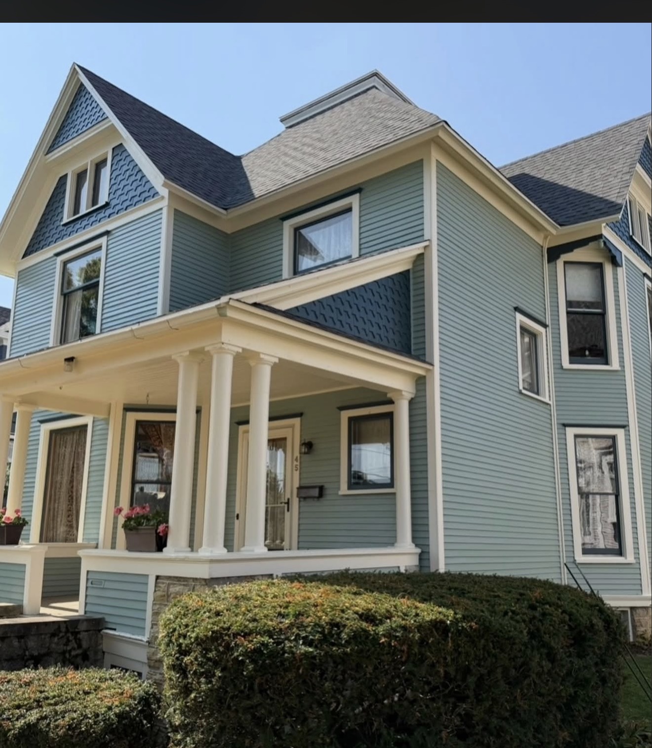 Blue and green Victorian home exterior painting