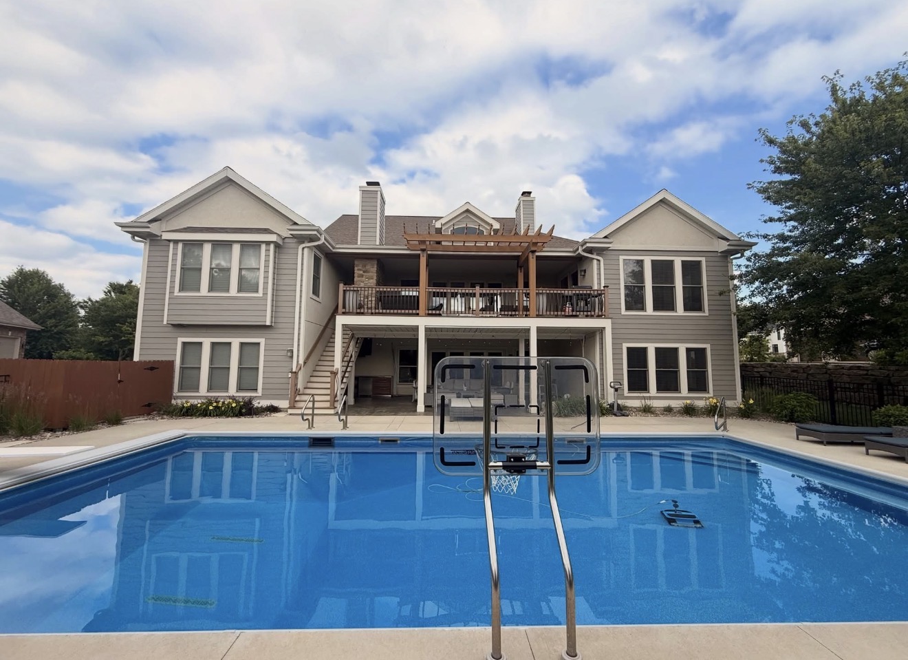 Residential exterior painting with poolside view